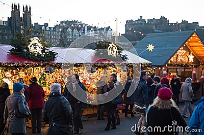 EDINBURGH, SCOTLAND, UK â€“ December 08, 2014 - People walking among german christmas market stalls in Edinburgh, Scotland, UK Editorial Stock Photo